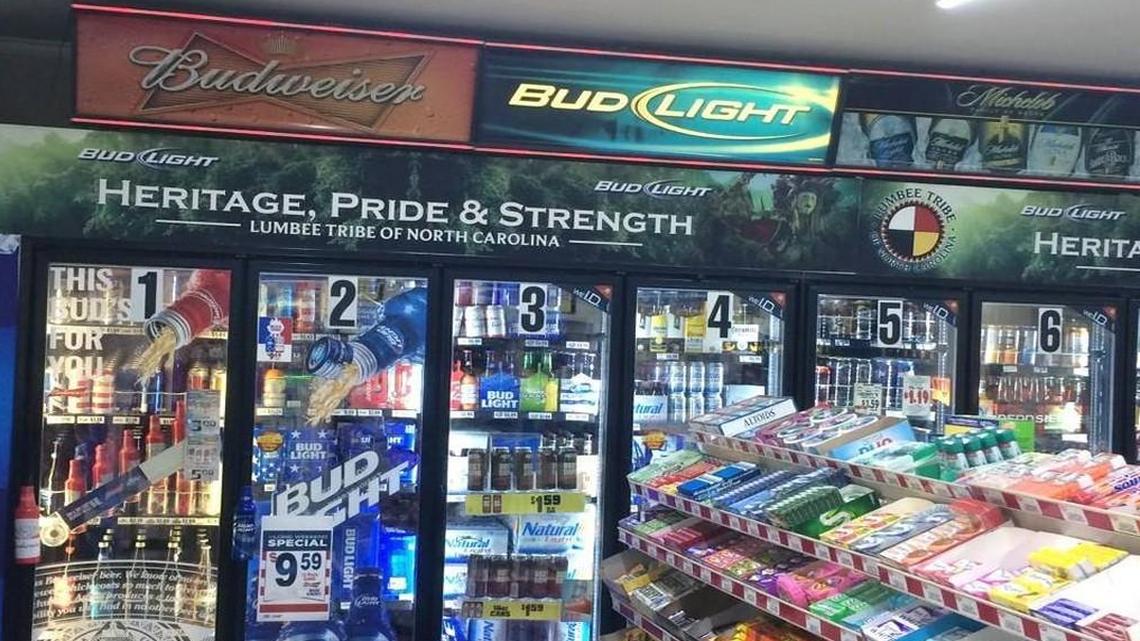 The Lumbee logo, top right, used with the “Heritage, Pride & Strength” slogan in an advertisement for Bud and Bud Light in a Lumberton convenience store. The Lumbee Tribe of North Carolina sued Anheuser-Busch and R.A. Jeffreys Distributing Company for illegally using the logo.