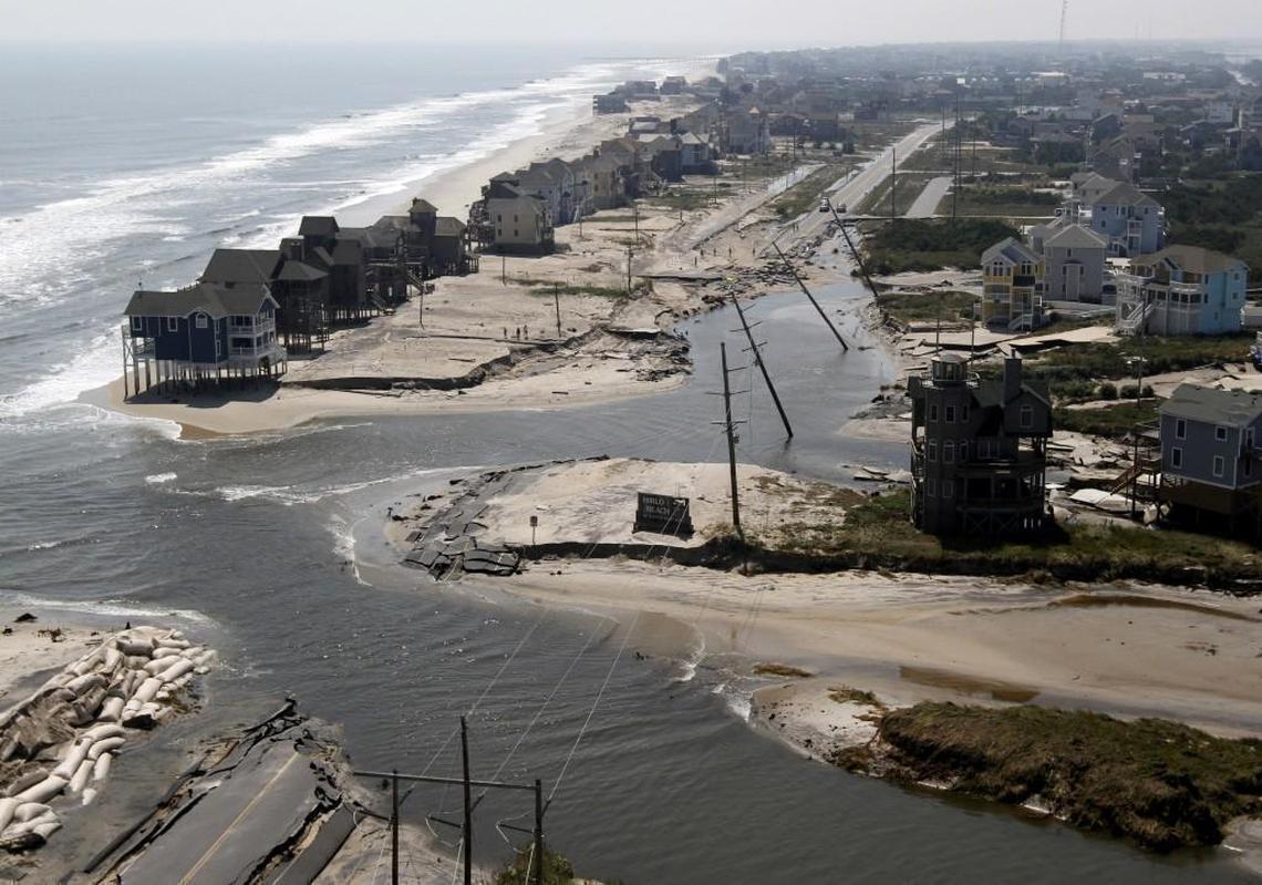 In this Aug. 28, 2011 photo, a flooded road is seen in Hatteras Island, N.C., after Hurricane Irene swept through the area Saturday cutting the roadway in five locations. Irene caused more than 4.5 million homes and businesses along the East Coast to reportedly lose power over the weekend, and at least 11 deaths were blamed on the storm. (AP Photo/Steve Helber, File)