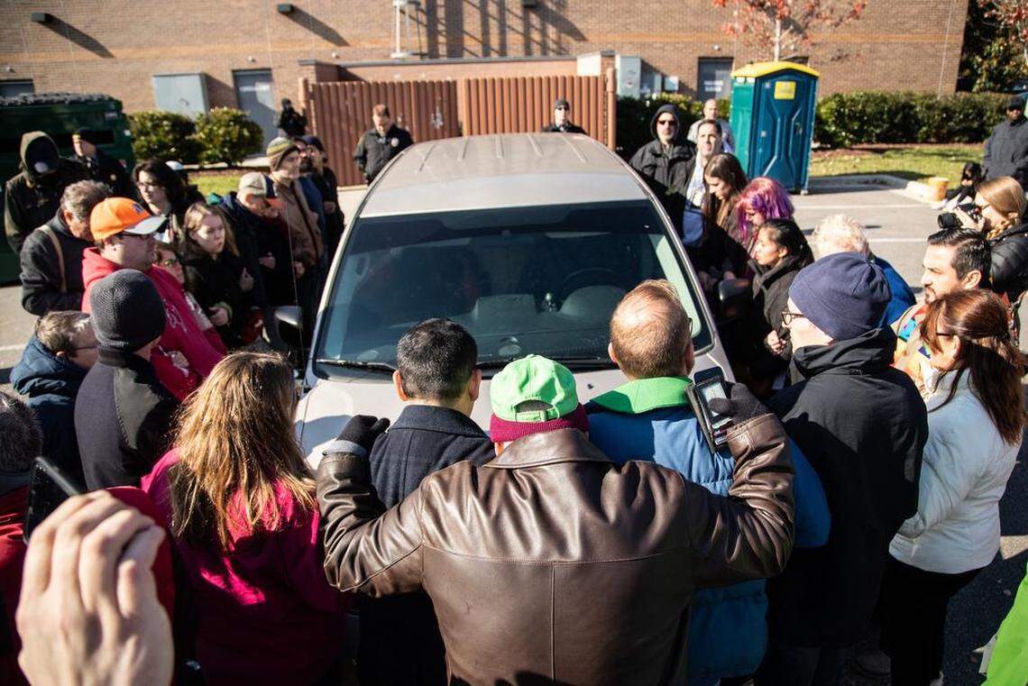Demonstrators surround a government vehicle after Samuel Oliver-Bruno, 47, an undocumented man was arrested Friday by immigration officers in Morrisville after he left the CityWell United Methodist Church of Durham where he has been living for 11 months. Churches are one of the few places where U.S. Immigration and Customs Enforcement do not make arrests.