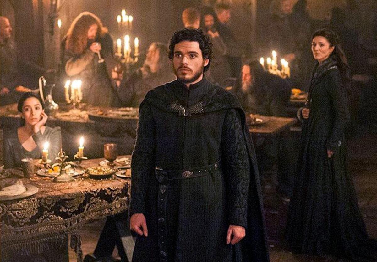 Robb Stark, center, his mother Catelyn, right, and his wife Talisa, left, just before things go horribly wrong in “The Red Wedding” episode of season three of “Game of Thrones.”