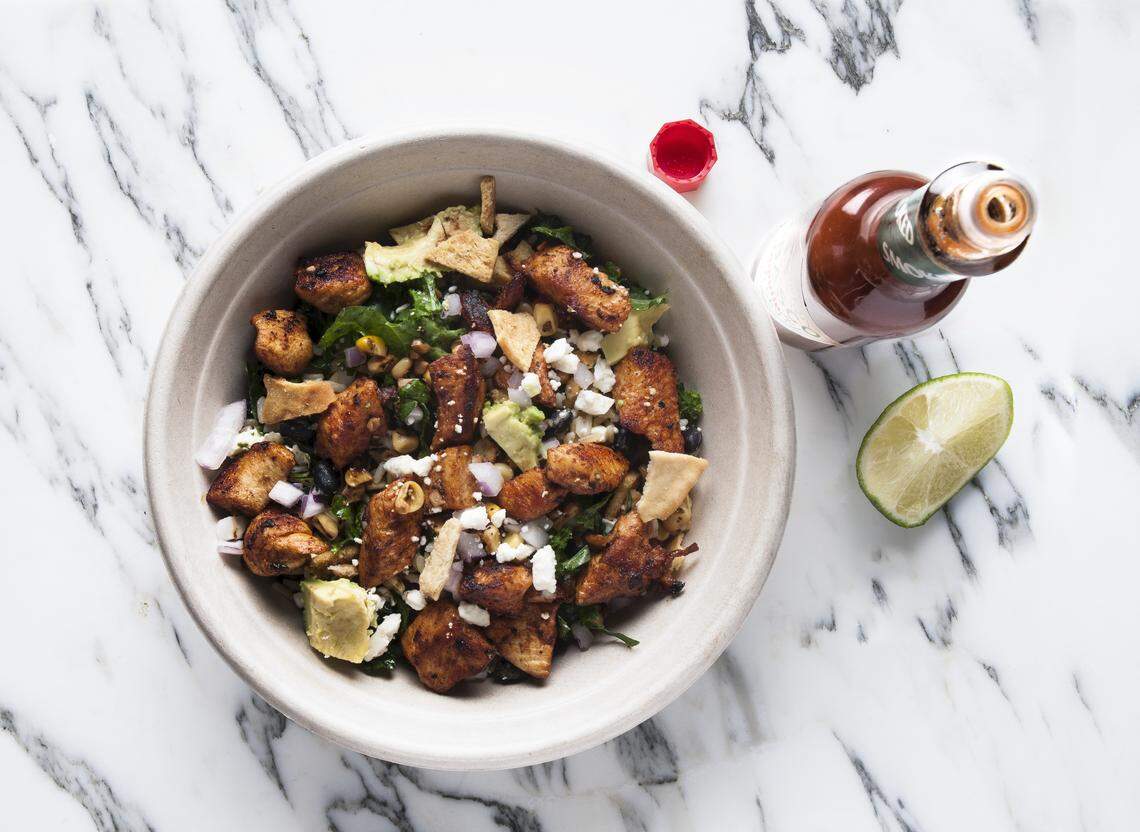 The El Jefe bowl at Roots Natural Kitchen is made with brown rice, kale, black beans, corn, red onions, avocado, pita chips and feta, with cilantro lime dressing and chicken.
