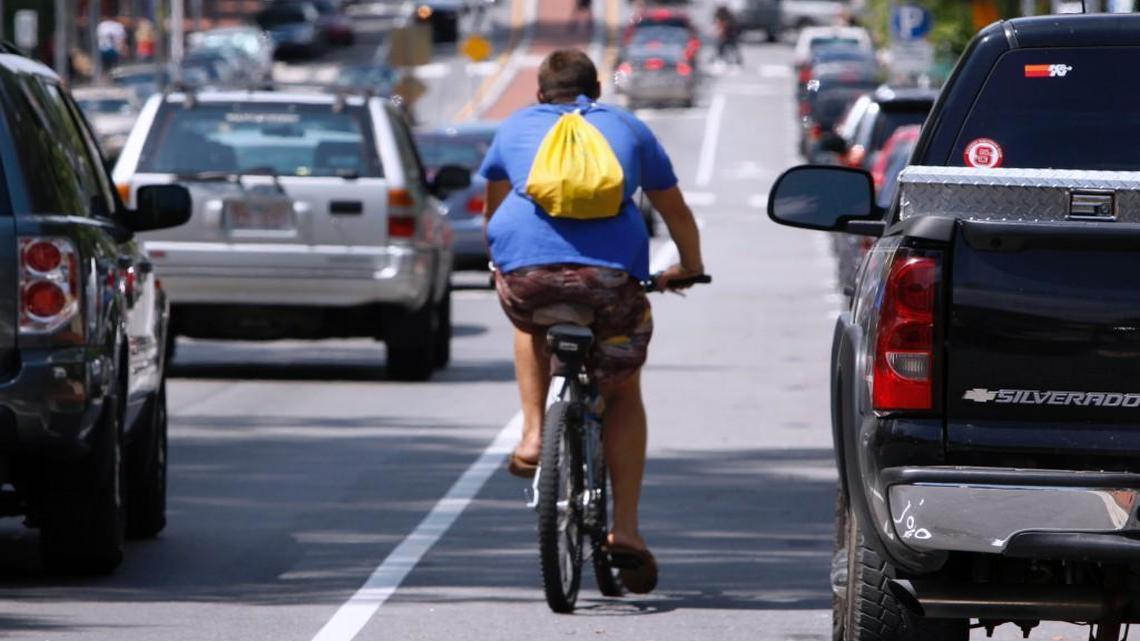 A bicyclist rides in a bike lane on Hillsborough Street in Raleigh.