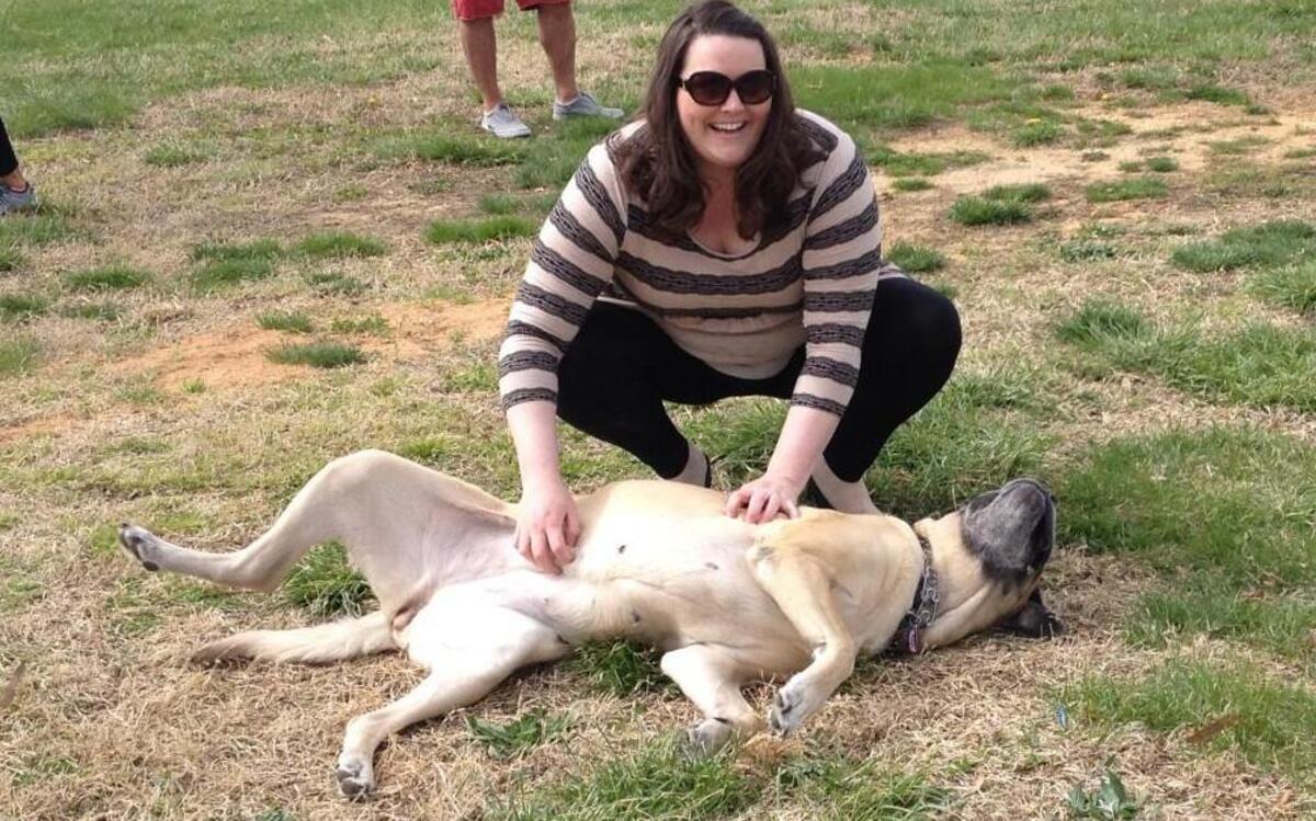Sarah Book treats her dog, Lucy, to a tummy rub at this year’s Doggie Easter Egg Hunt in Caswell County, hosted by AnimalKind.