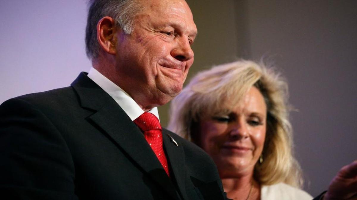 Alabama U.S. Senate candidate Roy Moore speaks at a news conference in Birmingham, Ala., with his wife, Kayla Moore, last week. A sex scandal has relegated Moore’s hard-line positions on LGBT issues to the background in Alabama’s turbulent Senate race.