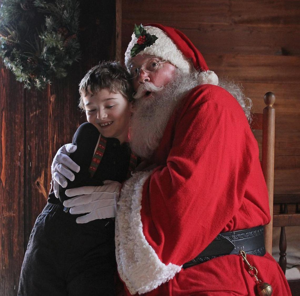 Tyler Eads, 7, of Wake Forest visits with Santa Claus at Bennett Place State Historic Site during "Christmas in the Carolinas During the Civil War" on Saturday, Dec. 12, 2015. Tyler visited Santa last year and brought a card and photos from that trip to give Santa this time. Does he believe? "One of his after-school counselors asked him if he'd told Santa what he wanted for Christmas," Tyler's mom, Sarah Cook said. "He said, 'Oh no, I haven't gotten to Durham yet to see him.'"