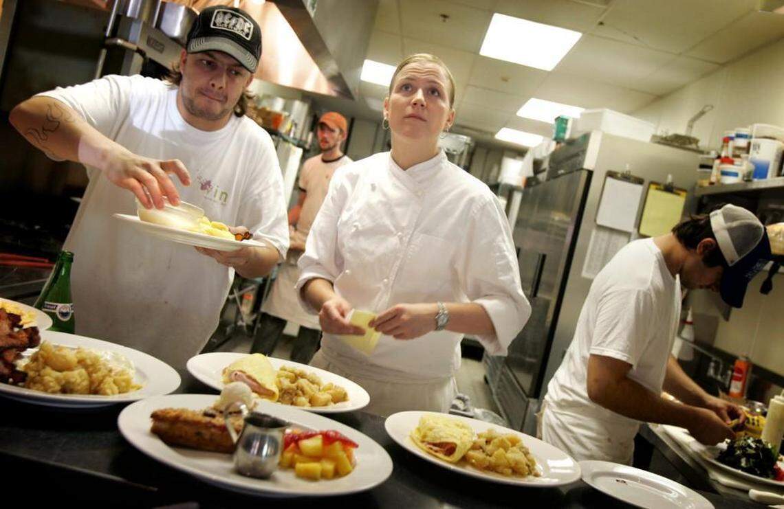 Brian O’Hara, left, and Ashley Christensen plate dishes during Sunday brunch at Enoteca Vin in 2004. The downtown Raleigh restaurant was featured in Food & Wine magazine and included several of Christensen’s recipes.