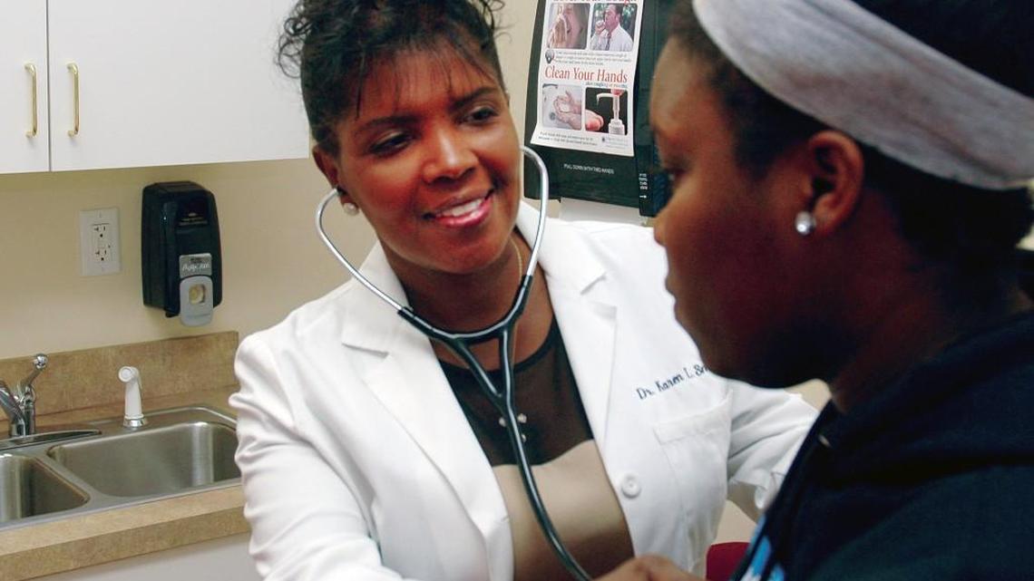 Raeford physician Dr. Karen Smith with an unidentified patient.