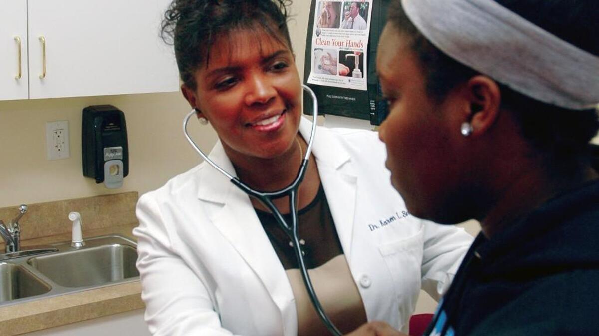 Raeford physician Dr. Karen Smith with an unidentified patient.