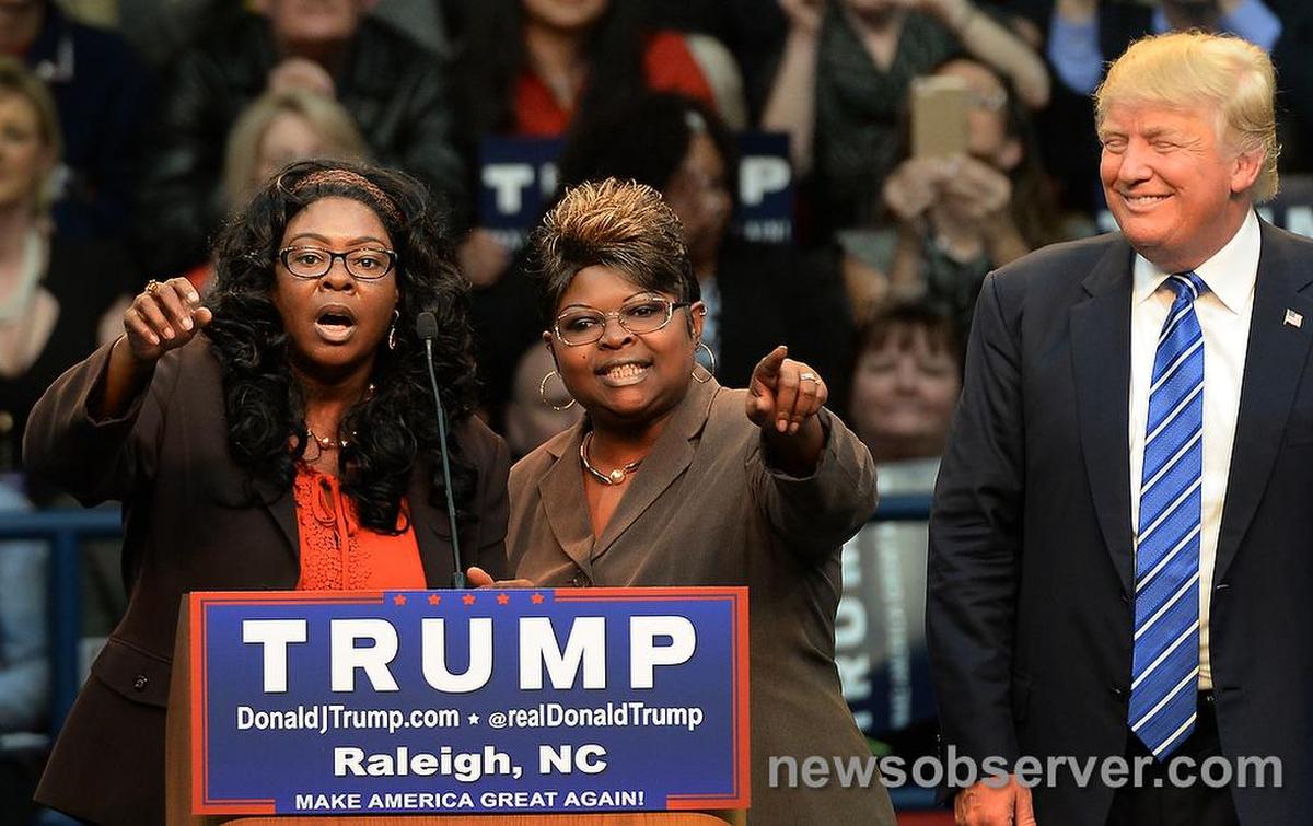 Republican presidential candidate Donald Trump smiles as Lynette “Diamond” Hardaway (left) and Rochelle “Silk” Richardson of Fayetteville voice their support as Trump smiles.