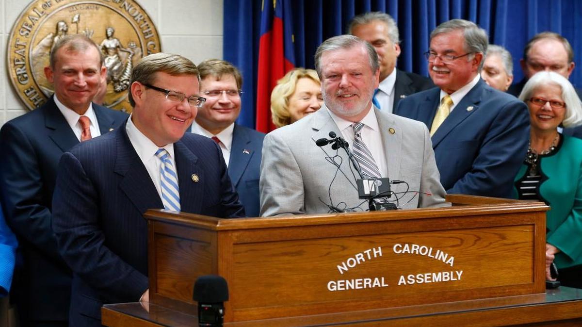 Flanked by members of both houses, Speaker of the House Tim Moore, left, and Senate Pro-tem Phil Berger announce that the two sides have reached a budget agreement at a press conference held at the State Legislature in Raleigh on Sept. 14, 2015.