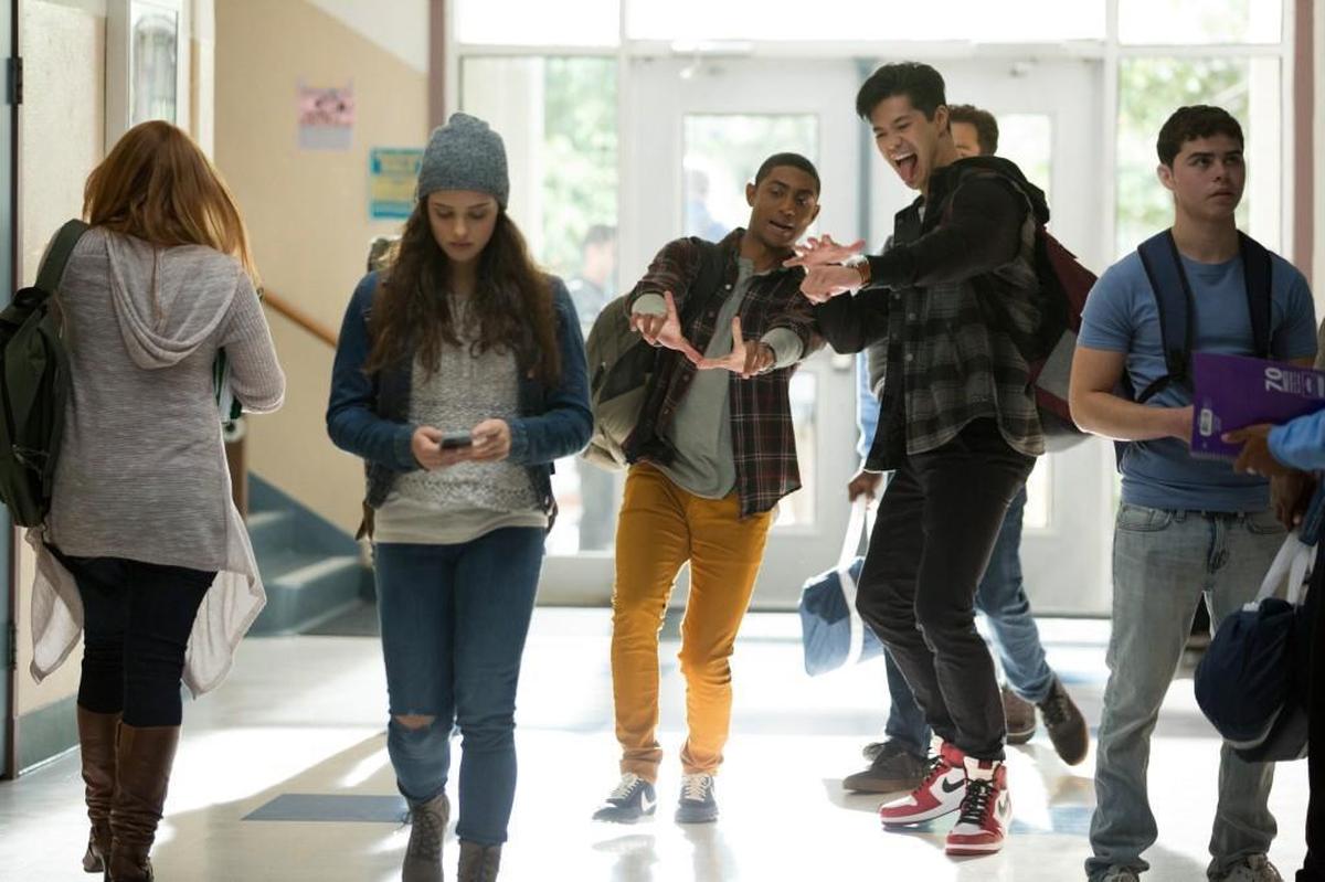 Katherine Langford, second from left, as Hannah Baker endures harassment from a group of male students in ‘13 Reasons Why,’ a Netflix drama series that explores the issues of bullying and teen suicide.