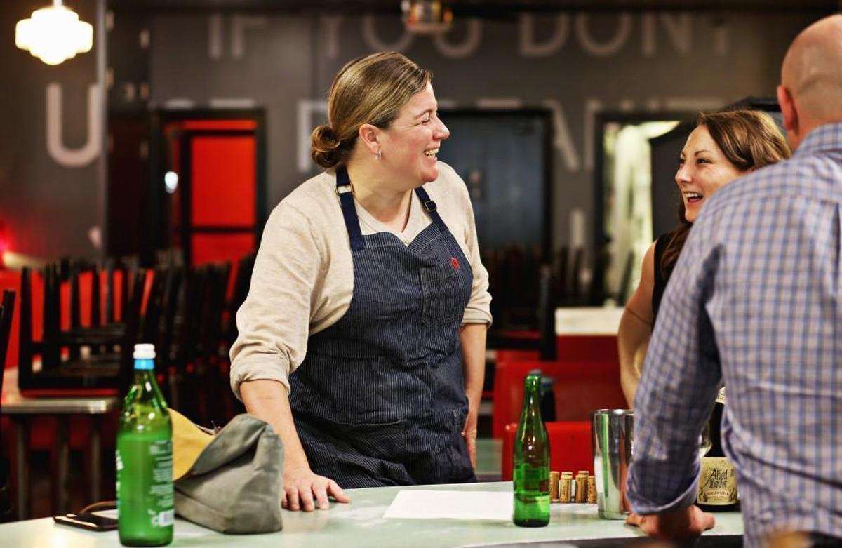 Chef Ashley Christensen, left, laughs with staff Oct. 29, 2017, at Poole’s Diner as they prepare for their annual Stir the Pot event.