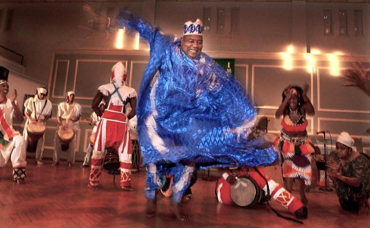Chuck Davis dances with members of The African American Dance Ensemble in 2017 during The 18th Annual KwanzaaFest in Durham.