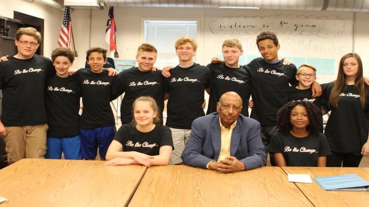 A group of eighth-grade students at the Exploris School is asking Wake County to name a future school after the Holt family, which includes Joe Holt Jr., center.