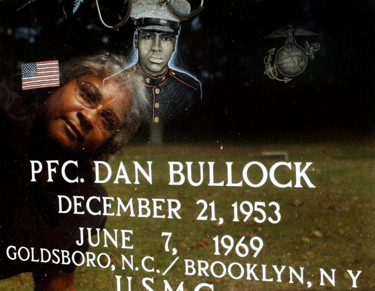 Porter Bullock Barnes is reflected in the tombstone of her brother, Dan Bullock, at the Elmwood Cemetary in Goldsboro in 2001.