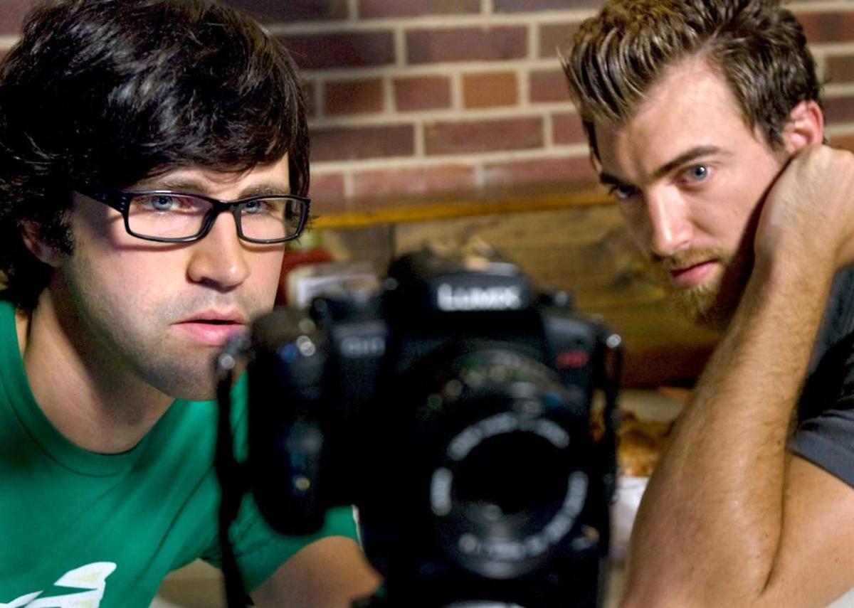 Link Neal, left, and Rhett McLaughlin review video in 2010 at Cooley’s Restaurant and Pub in Fuquay-Varina, where they worked until relocating to Los Angeles.