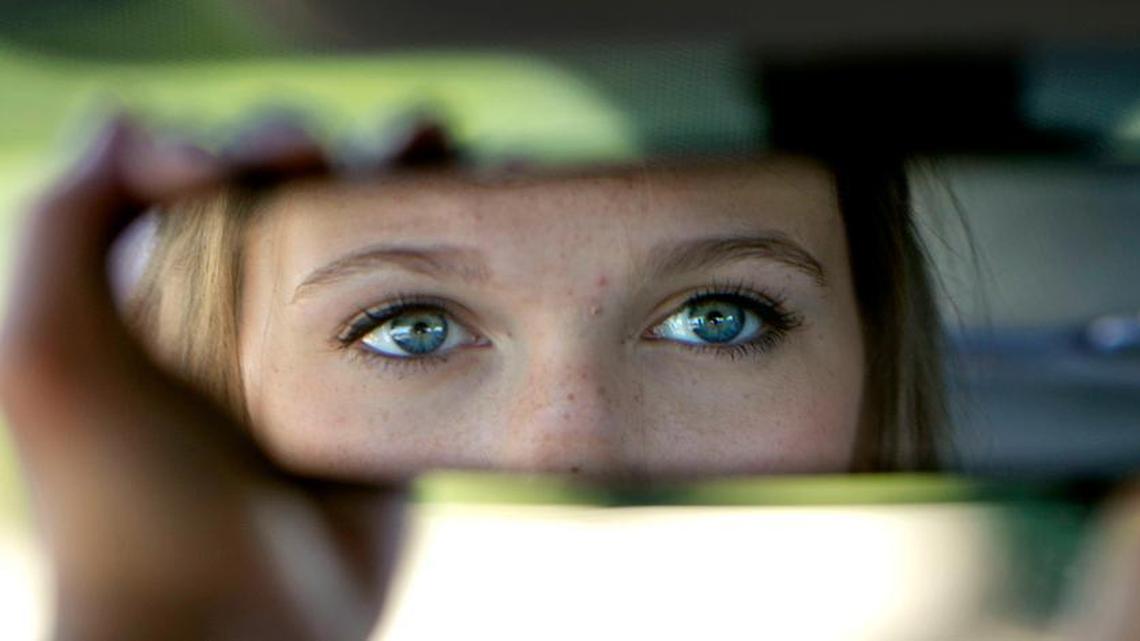 Student driver Courtney Barron, a rising sophomore at Cary High School, adjust the mirror in one of the Jordan Driving School automobiles as she takes the wheel for some driving time at Middle Creek High School in Cary, N.C. on Monday June 22, 2015.