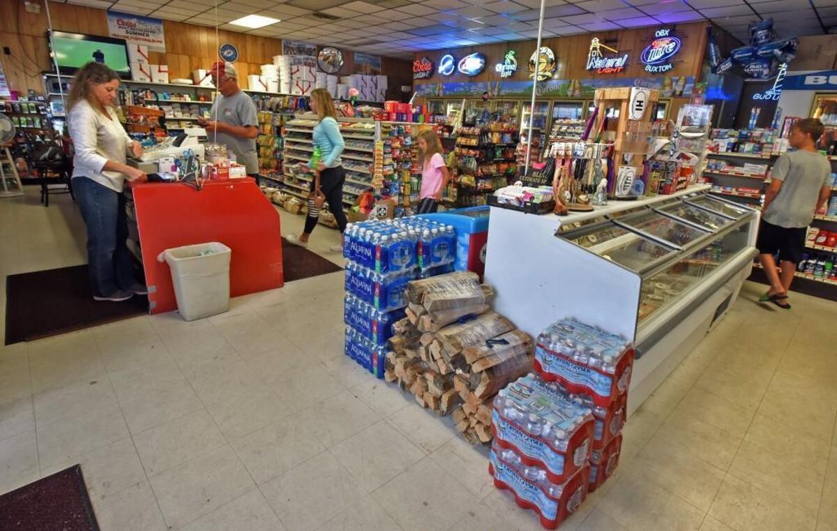 Barbara Gray checks out customers at the Red Drum Food Mart in Buxton, N.C., Saturday, July 29, 2017. Power was restored to most of the residents after generators were installed around the island. A construction crew severed the power cable that supplies electricity to Hatteras Island on Thursday as they worked on the new Bonner Bridge construction at the north end of the island.