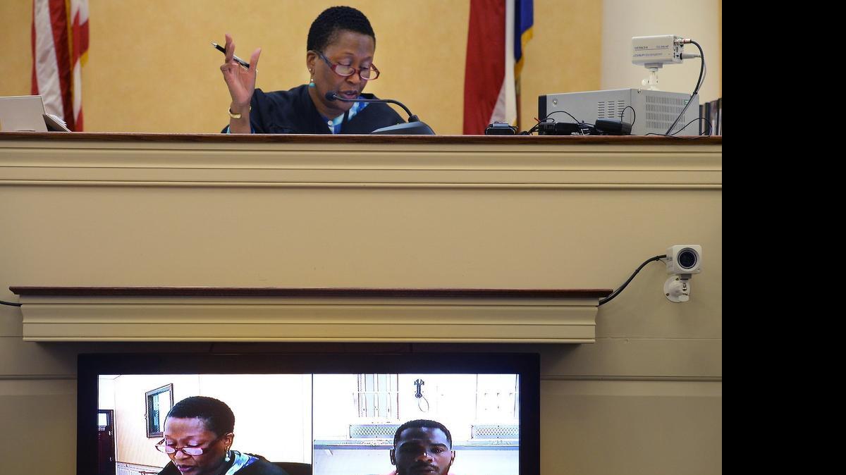 
Orange County District Court Judge Beverly Scarlett questions former UNC football player Chris Hawkins via a video arraignment at the Orange County courthouse in Hillsborough Tuesday. Hawkins has been arrested and charged with acting as an agent and violating North Carolina's law that bars luring collegiate athletes into contracts. His bond was reduced from $500,000 to $300,000.
