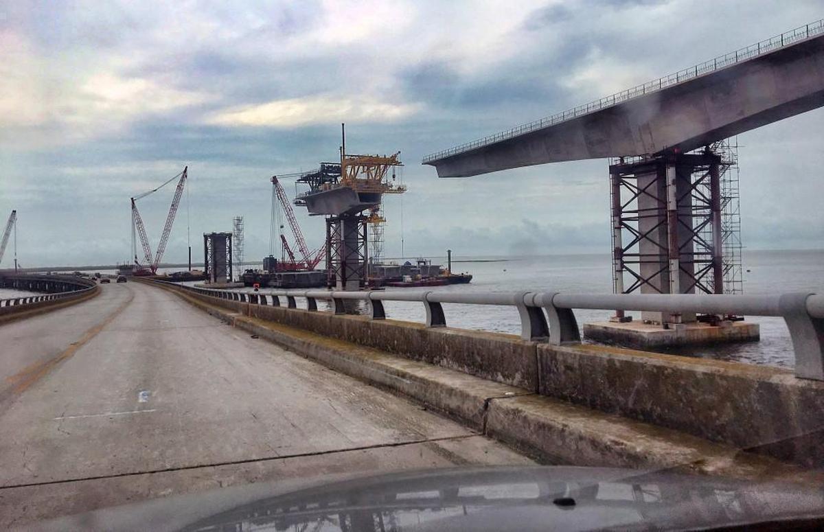 PCL Construction, the company building the new Bonner Bridge (right), says that at about 4:30 a.m. on Thursday, its crews drove a steel casing into the underground transmission cable running between the south end of the bridge and the overhead riser pole, causing the outage.