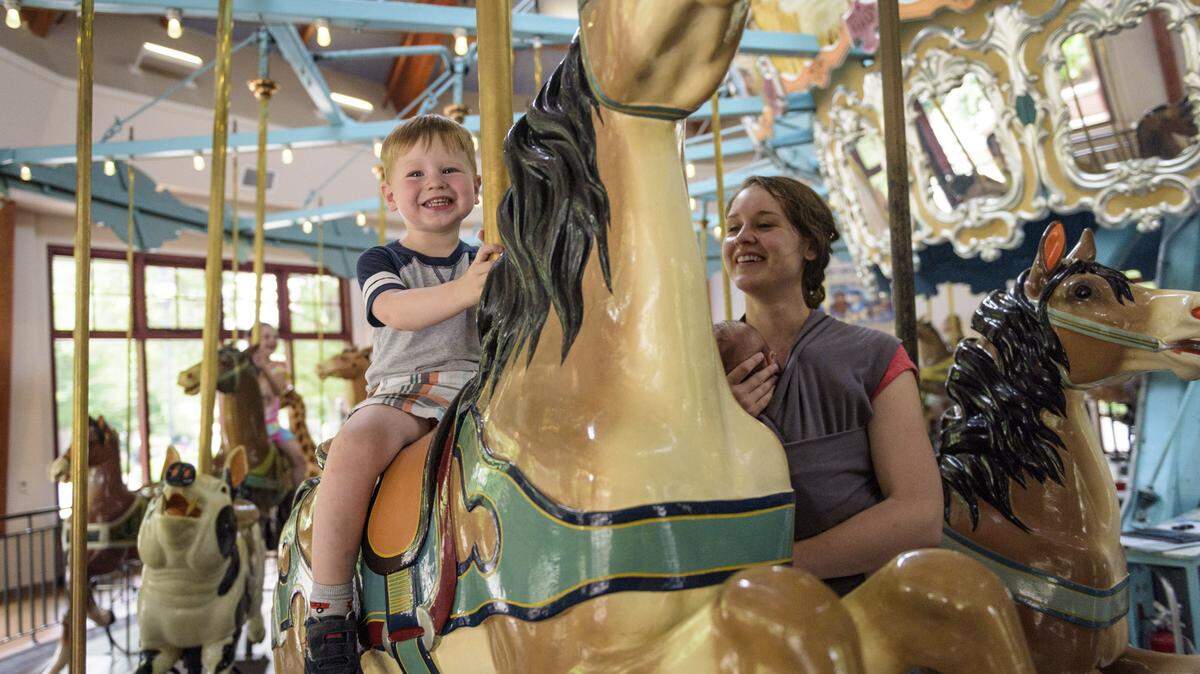 Emerson rides the carousel with his mom, Lauren, at Pullen Park in Raleigh, NC at on June 19, 2019.