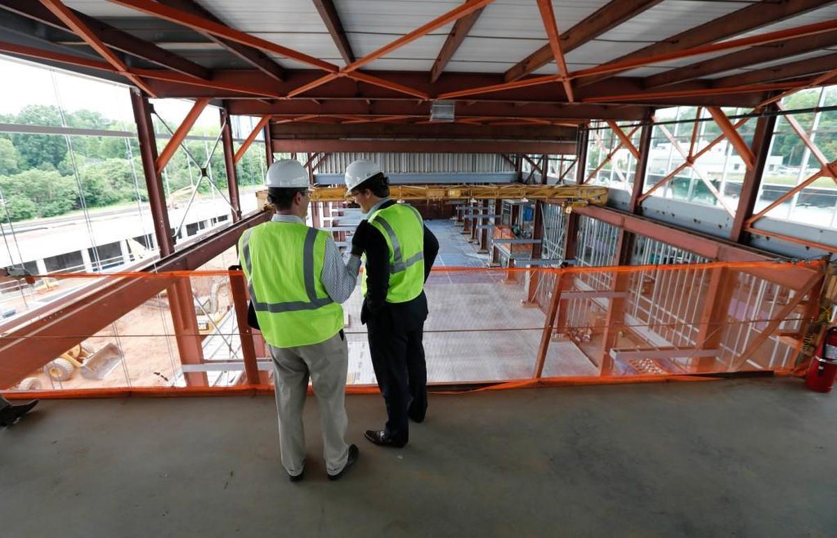 Raleigh city manager Ruffin Hall, left, talks with city council member Bonner Gaylord during a tour of Raleigh's Union Station Tuesday, May 9, 2017.