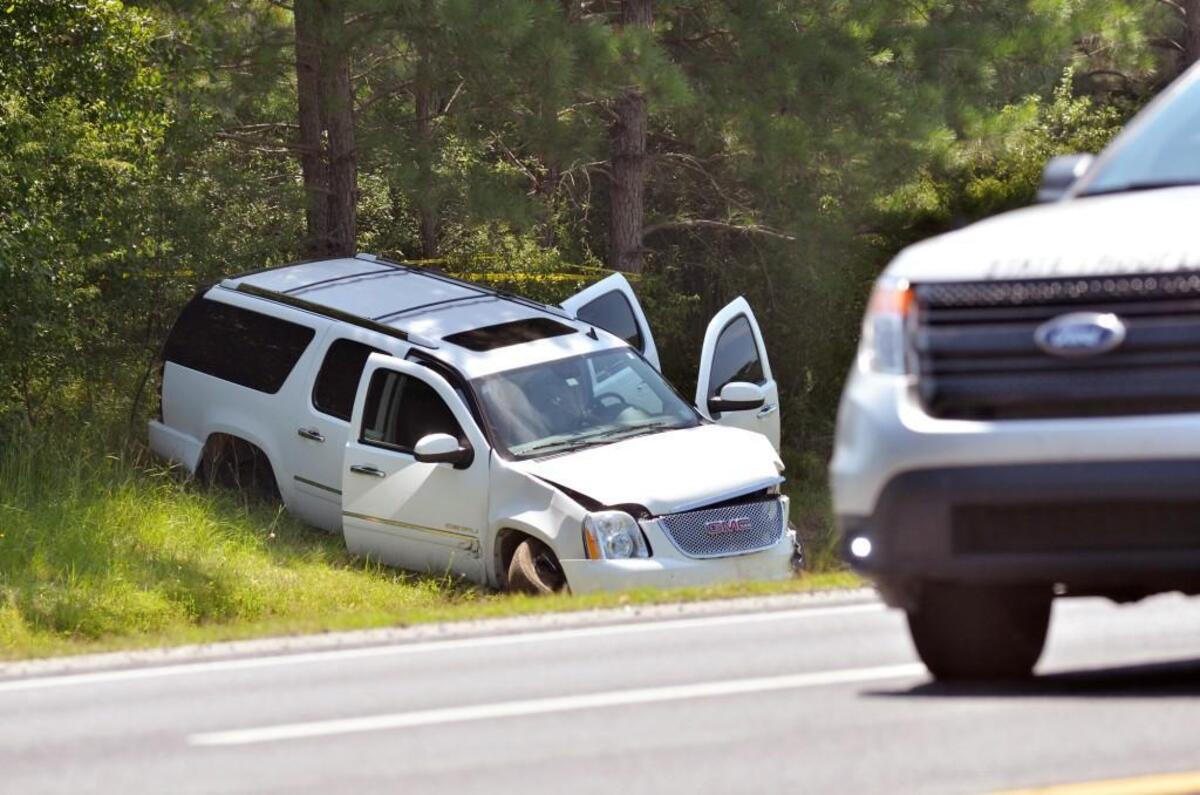 A wrecked SUV is shown at the scene where officials were involved in a shooting on westbound Interstate 40 near Benson, N.C. Saturday, July 8, 2017.