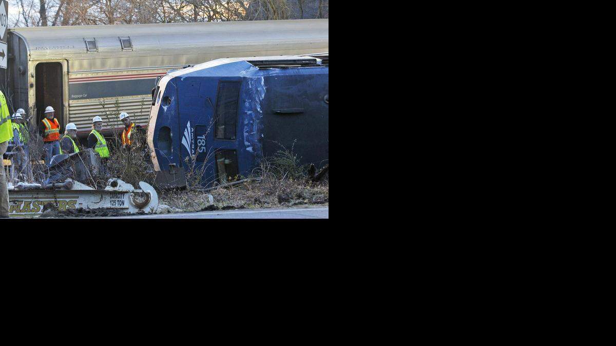 A northbound Amtrak train collided with a tractor-trailer carrying an oversize load when the truck got stuck on the tracks in Halifax, NC on Monday, March 9, 2015. More than 200 passengers were on the train bound for New York. None had life-threatening injuries. Here, workers inspect damage to an overturned car.