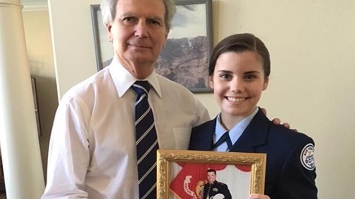 Congressman Walter Jones with Brooke Gruber holds a photo of her father Marine Corps Maj. Brooks Gruber, who died in the crash of a V-22 Osprey during a training flight in April 2000.
