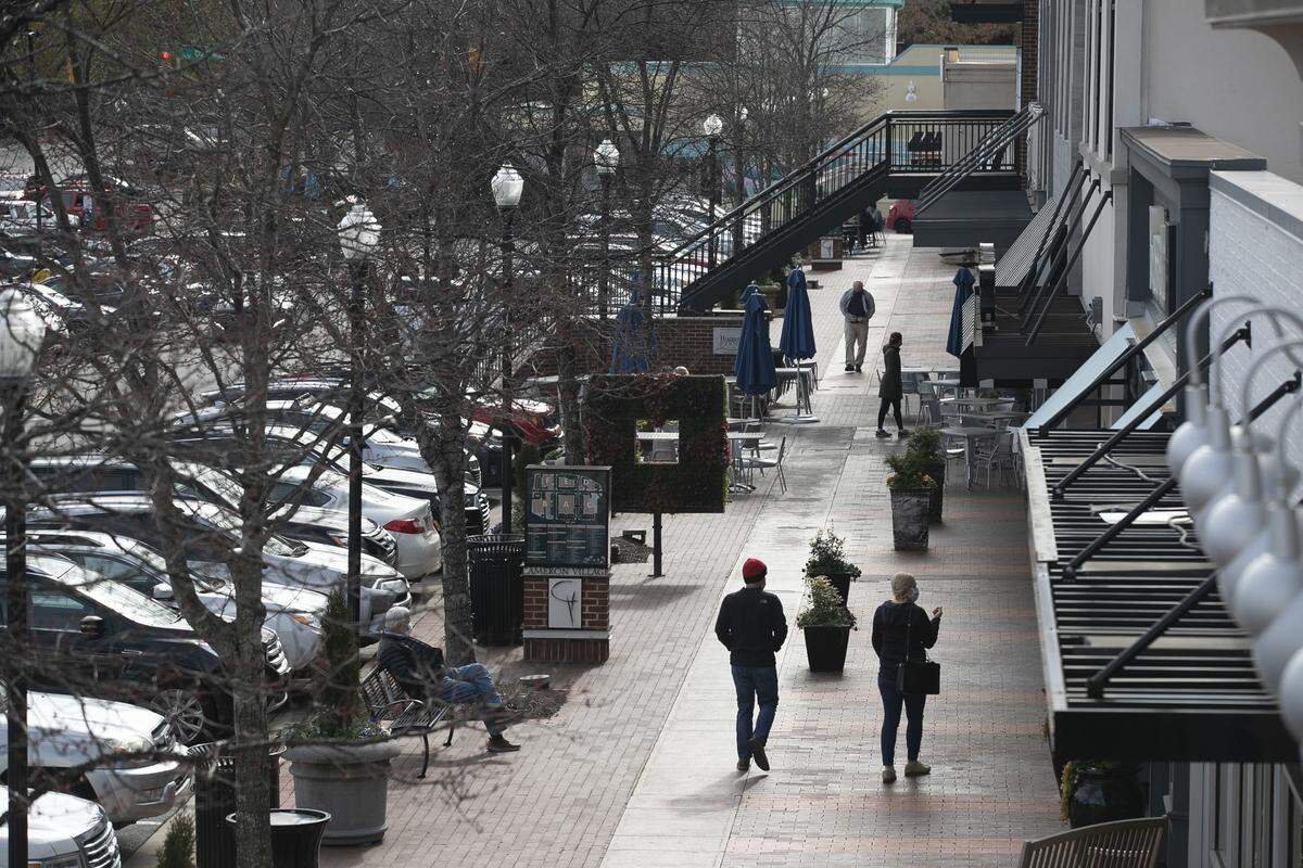 Shoppers in the Village District, formerly Cameron Village shopping center, traverse the area along Daniels Street near Cantina 18 and Carolina Lighting & Design on Saturday, January 30, 2021 in Raleigh N.C.