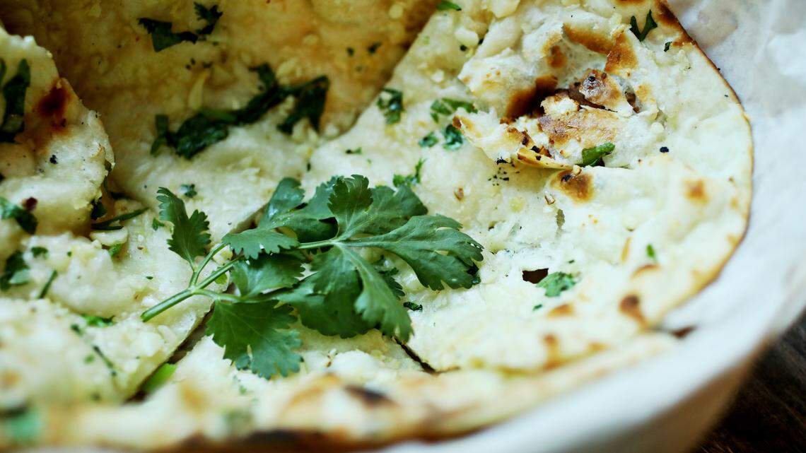 The garlic naan, topped with garlic and fresh herbs, is one of several breads on the menu at Lime & Lemon’s new restaurant in Apex.