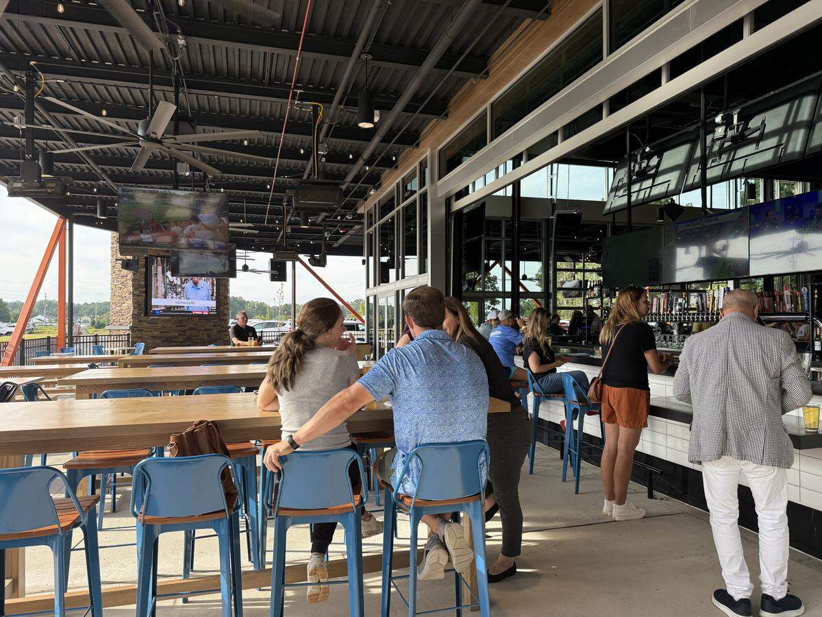 Huge windows can be raised to create an indoor/outdoor bar at McWally’s. Customers can sit at the bar or on the covered patio.