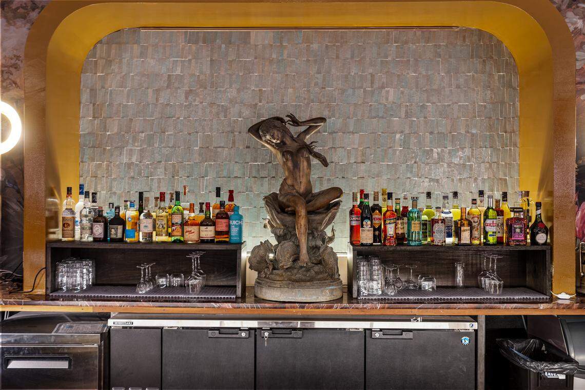 A fountain at Capulet Cocktail Club allows visitors sitting at the curved bar to watch water flow down the tiles.