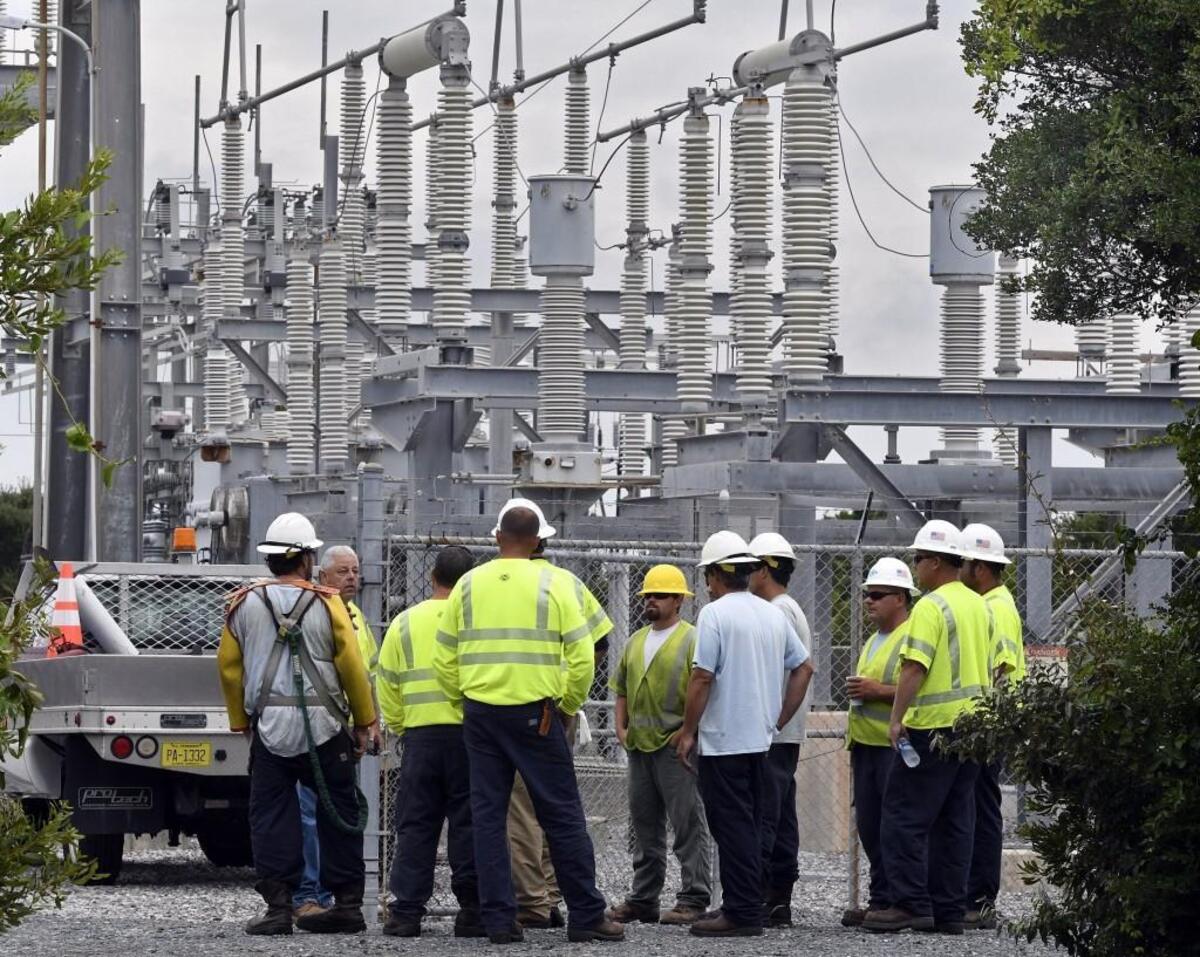 Cape Hatteras Electric Cooperative linemen get orders from a supervisor at a Hatteras Island substation where generators are running Saturday, July 29, 2017, after a construction crew cut the power cable that supplies Hatteras Island with electricity.