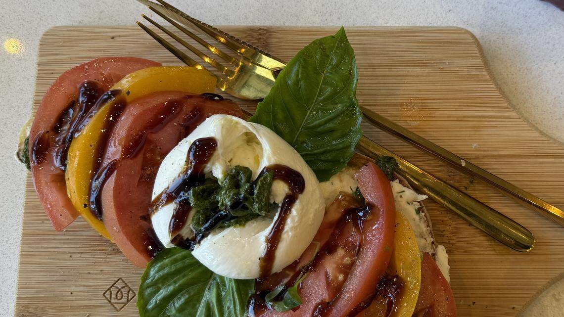 The tomato burrata toast from Toastique is made with a ricotta spread, topped with tomatoes, burrata, pesto, fresh basil, oil and balsamic glaze.