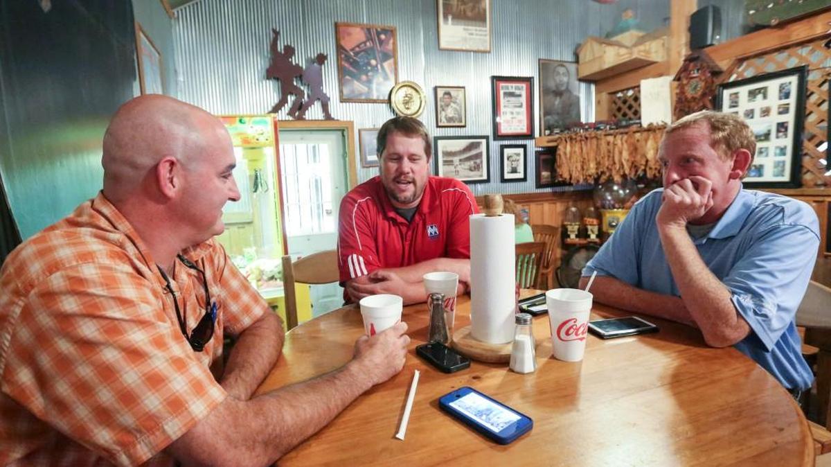 
From left, Patrick Jackson, Brian Eaton and Tim Moore talk about the legend of the Lizard Man at the Harry and Harry Too restaurant in Bishopville, S.C. The restaurant has capitalized on the alleged creature, first reported in 1988, with a special sandwich. attraction of Lizardman even offering a sandwich called The Lizardman. The grilled chicken sandwich with sauteed mushrooms and onions is a favorite for locals and those lured to the restaurant by the lore of Lizardman.
