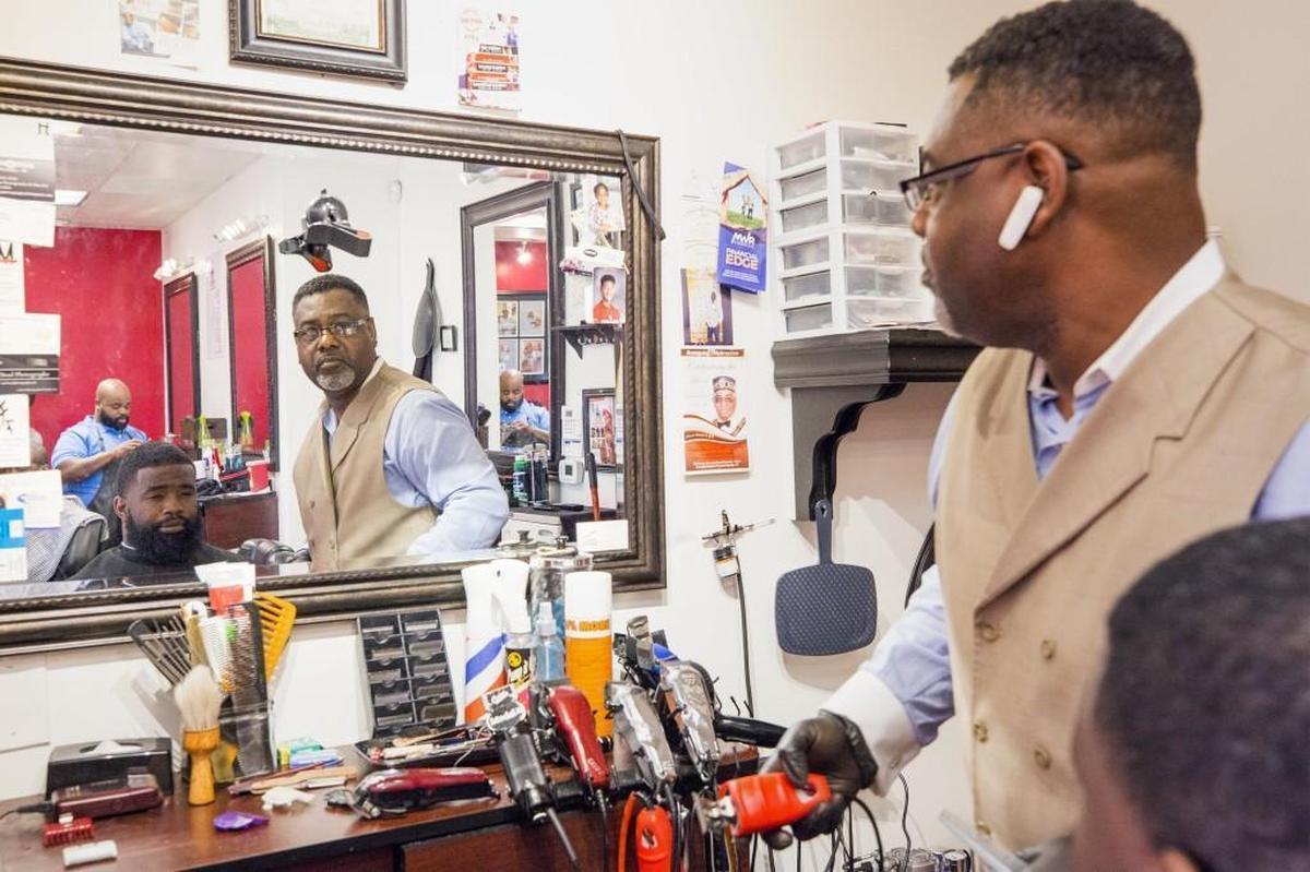 William Winters, who used to be homeless, gives Cliff Jarman a haircut at Mr. GroomRoom Barber Shop in Raleigh on Sunday, Jan. 21, 2018. Winters now gives free haircuts to the homeless, including Jarman.