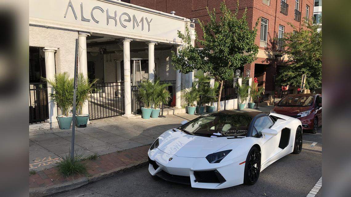 A Lamborghini with two parking citations on its windshield sits in front on Alchemy on Glenwood Ave. in Raleigh on Monday, June 25, 2018.