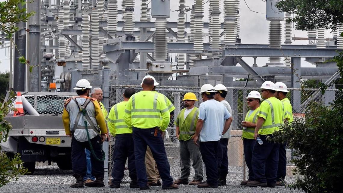 Cape Hatteras Electric Cooperative linemen get orders from a supervisor at a Hatteras Island substation where generators are running after a construction crew cut the power cable that supplies Hatteras Island with electricity, Saturday, July 29, 2017. The men were to man the generators and monitor fuel and discharge rates to keep local residents out of the dark.