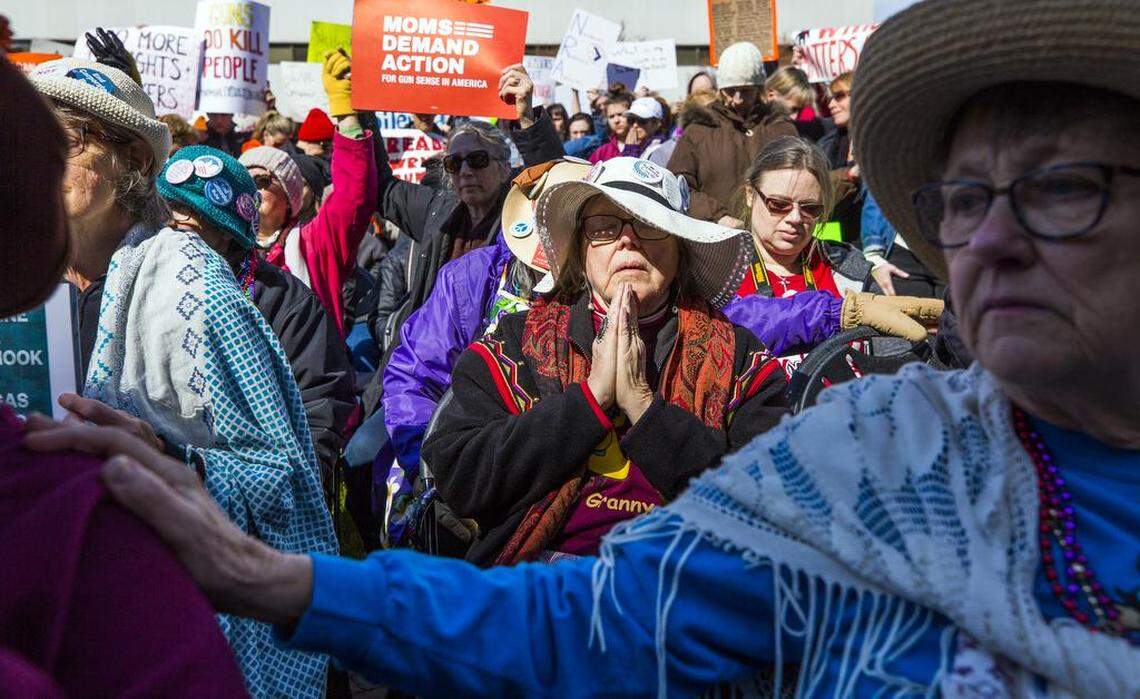 Gail Carson, of the Raging Grannies, joins the crowd in a prayer led by Nancy Petty, pastor of Pullen Memorial Baptist Church, during the March For Our Lives rally on the Halifax Mall in Raleigh, NC, on Saturday, Mar. 24, 2018, raising awareness about gun violence and gun control after the mass shooting at Marjory Stoneman Douglas High School on Feb. 14, 2018.