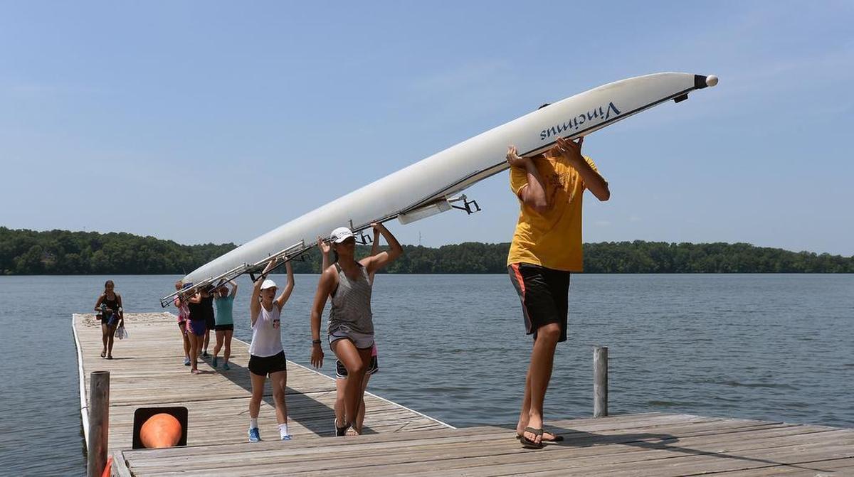 After finishing two hours of rowing the boaters carry the skull back to the storage area at Raleigh's Lake Wheeler Wednesday, June 24, 2015. 