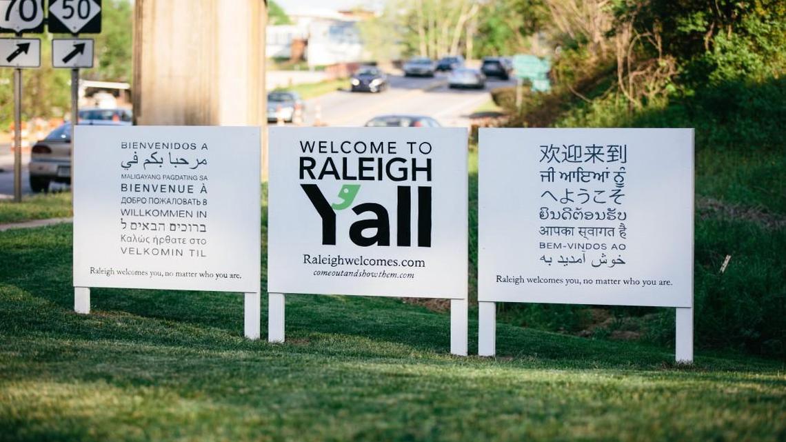 A sign on Wade Avenue, part of a campaign by Come Out and Show Them, welcome people to Raleigh in 17 different languages.