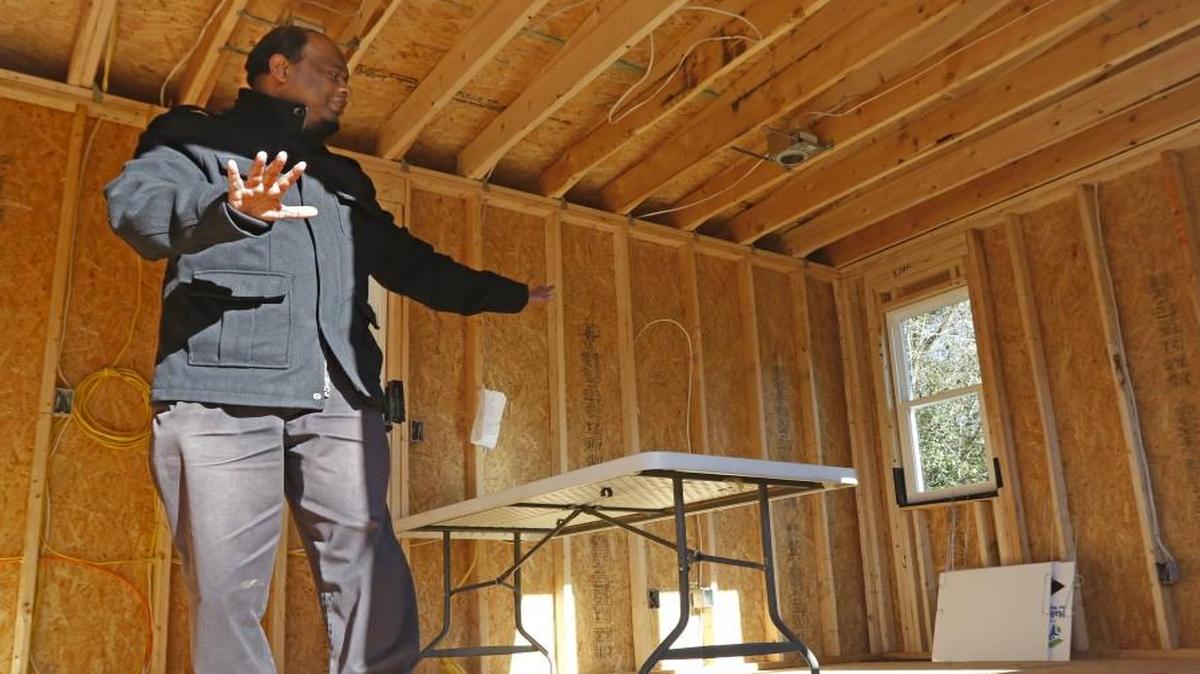 Thava Mahadevan, director of operations at the UNC’s Center for Excellence in Community Mental Health tells visitors about the interior floor plan of the first project tiny house, a 12 foot X 28 foot one story house, The Margaret B. Pollard Tiny House built in fall, 2015. The 336 square foot house is the pilot house, the first of several at The Farm at Penny Lane where clients with mental illness will be able to live inexpensively in a planned tiny house community for people with mental illnesses just south of Chapel Hill.