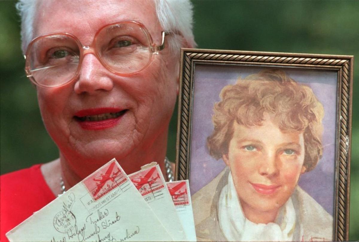 Helen Tucker Beckwith holds a portrait of Amelia Earhart cut from a magazine and letter she received from Amelia Earhart's mother in the 1940s.