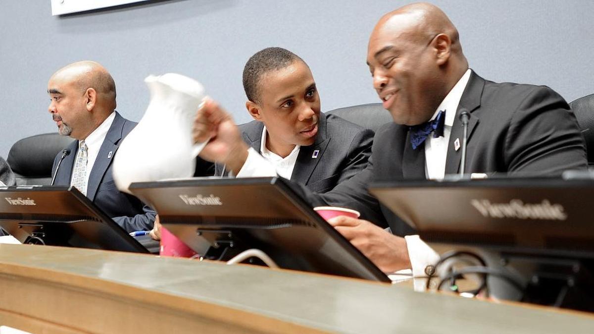 Durham City Council member Vernetta Alston, center, talks with member Mark-Anthony Middleton, right, at Durham City Hall.