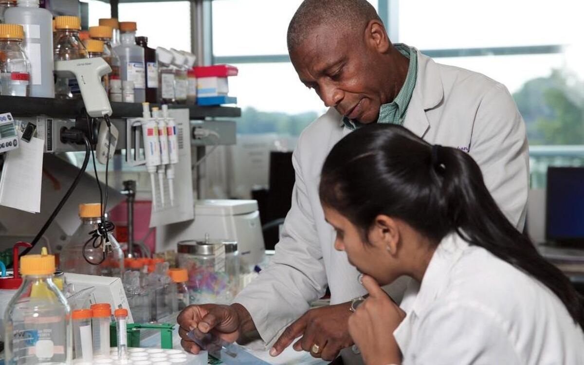 Ricardo Richardson, biology professor and director of cancer research at N.C. Central University, confers with postdoctoral fellow Vandana Singh at NCCU.