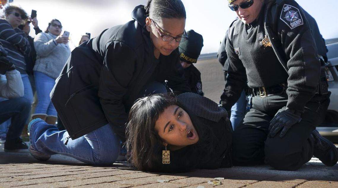Protestors are arrested after detaining a Department of Homeland Security van containing Samuel Oliver-Bruno, 47, who was arrested after being asked to appear at the United State Citizenship and Immigration office in Morrisville, N.C. on Friday, November 23, 2018. Samuel Oliver-Bruno had been living in the sanctuary of CityWell United Methodist Church for 11 months because churches are one of the few places where U.S. Immigration and Customs Enforcement does not make arrests. Wake County Sheriff’s deputies and Morrsiville Police made several arrest of the protestors surrounding the van containing Oliver-Bruno.