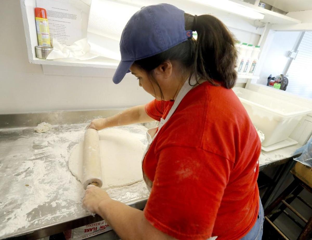 Debbie Lewis rolls out a batch of biscuits at the NC State Fair booth operated by The First United Methodist Church of Cary and White Plains United Methodist Church on Monday, Oct. 19, 2015.
