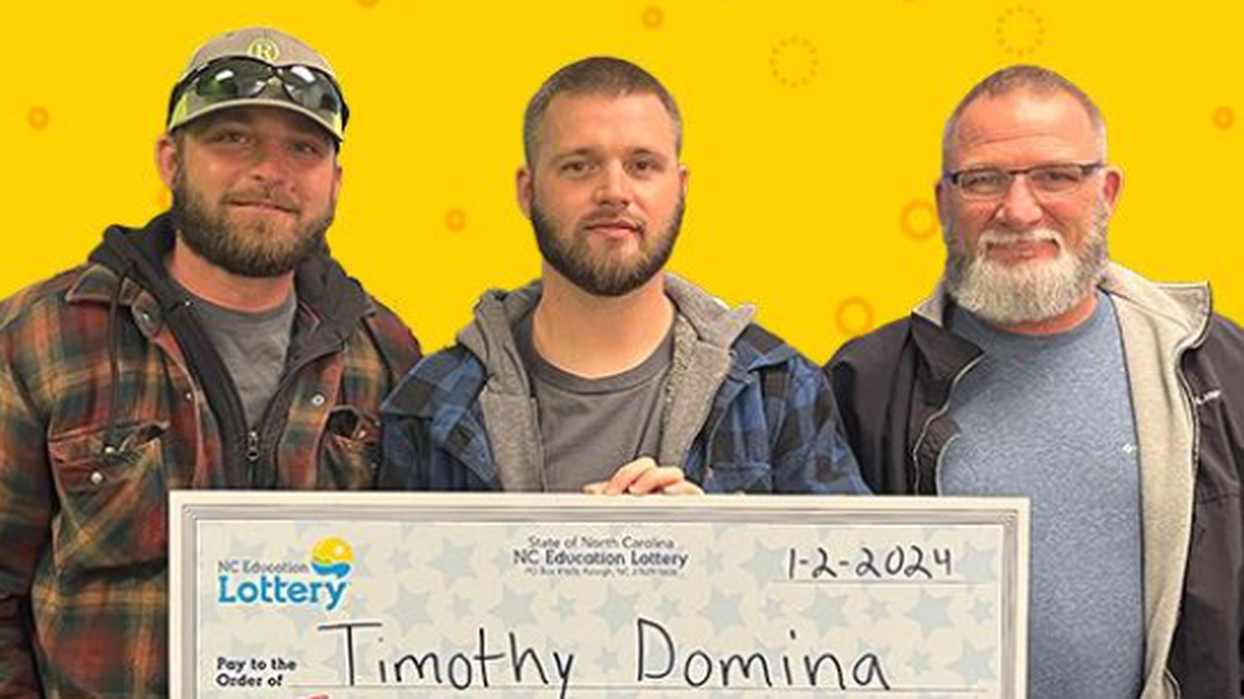 Timothy Domina, center, is pictured with his brother Josh and dad David after winning big in the North Carolina lottery.