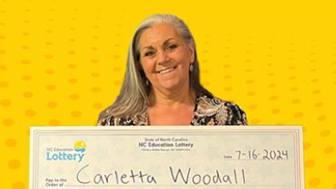 Carletta Woodall spent $1 on a lottery ticket that was worth much more. Now, she hopes to spend her prize money on a vacation.